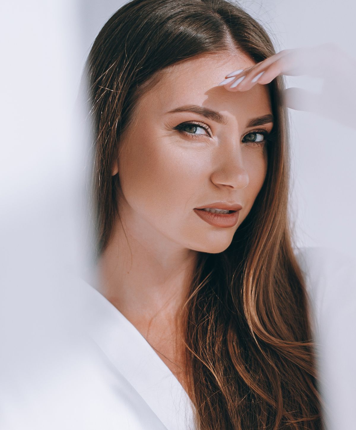 Woman with closed eyes and elegant necklace.