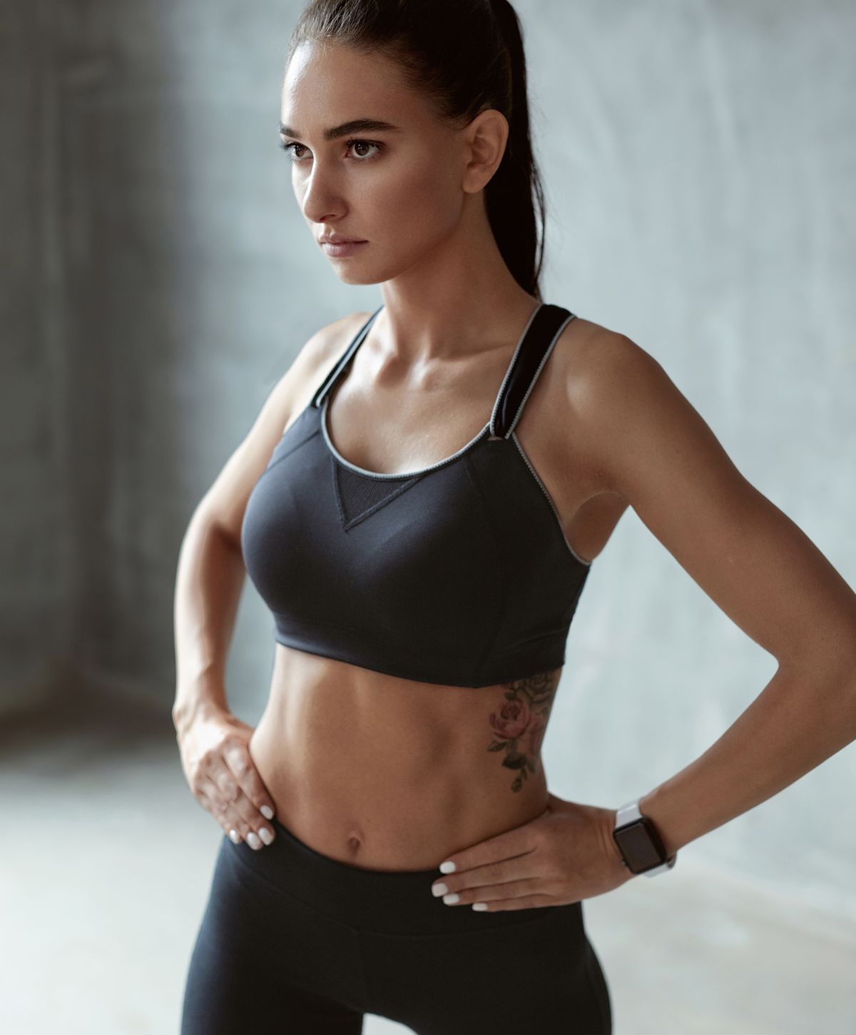 Woman in fitness attire showcasing athletic pose.