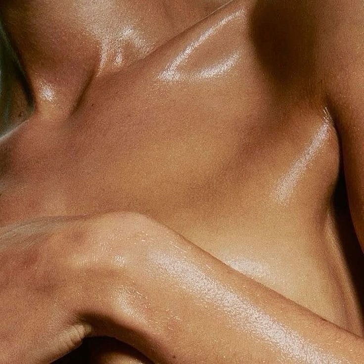 Glowing skin with artistic lighting and shadows.